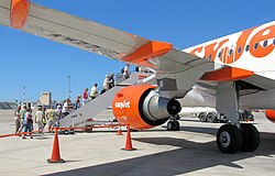A commercial aviation scene at Palma de Mallorca, the airport of Mallorca, Spain. Passengers board an EasyJet Airbus A320 (2010)