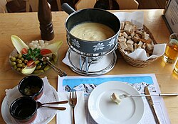 Fondue is melted cheese, into which bread is dipped.