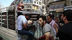 Wounded civilians arrive at a hospital in Aleppo, October 2012