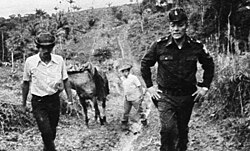 Omar Torrijos (right) with farmers in the Panamanian countryside. The Torrijos government was well known for its policies of land redistribution.[65]