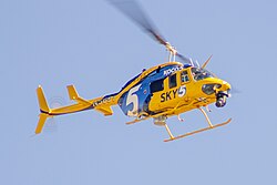 A helicopter in a yellow and blue livery with a large KOCO 5 logo and the text "Sky 5"
