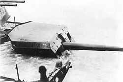 Admiral Graf Spee's Number Four 15.0 cm/55 gun mount (second gun in the forward port side group). Twin gun barrels at upper left are those of the ship's Number Two 10.5 cm/65 anti-aircraft gun mount