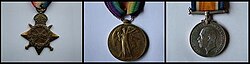 Three medals left a bronze star with the King's crown at the top and diagonally crossed swords, centre Winged Victory with right arm held aloft, right silver medal with the uncrowned head of King George facing right