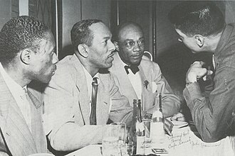 At the Café Society, from left: Joe Williams, Andy Kirk, Edmond Hall, and John Hammond