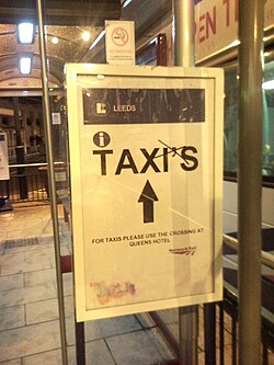 Sign at Leeds railway station, England, with an extraneous apostrophe crossed out