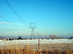Three-phase high-voltage electric power transmission lines use alternating currents to distribute power over long distances between electric generation plants and consumers. The lines in the picture are located in eastern Utah.