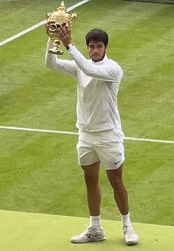 Alcaraz holding the Gentlemen's Singles Challenge Cup after winning the 2023 Wimbledon Championships