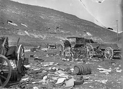 Two soldiers in background near staff car
