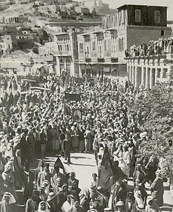 A crowd mourning King Faisal gather in front of the municipality street in Amman, Transjordan in 1933