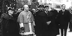 Enthronement as Co-Prince in 1942 of Bishop Ramón Iglesias (centre). The local comite was led by Francesc Cairat (left), the First General Syndic with the longest regencie, from 1936 to 1960.[101]