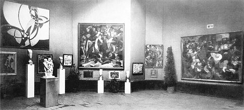 The Salon d'Automne of 1912, held in Paris at the Grand Palais from 1 October to 8 November. Joseph Csaky's sculpture Groupe de femmes of 1911–12 is exhibited to the left, in front of two sculptures by Amedeo Modigliani. Other works by Section d'Or artists are shown (left to right): František Kupka, Francis Picabia, Jean Metzinger and Henri Le Fauconnier.