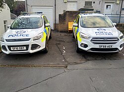 Monolingual (English) and bilingual (English and Gaelic) vehicle decals; both display a stylised Royal Badge of Scotland (a thistle surmounted by the Crown of Scotland) and the motto Semper Vigilo, Latin for "Always vigilant."