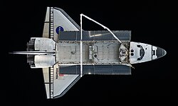 Atlantis in orbit in 2010. Image shows the payload bay and the extended Canadarm.