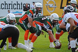 A quarterback for the Kiel Baltic Hurricanes in Germany under center and ready to take the snap
