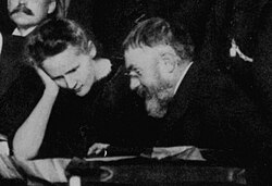 Marie Curie and Poincaré talk at the 1911 Solvay Conference.