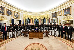 President Donald J. Trump in his capacity as commander-in-chief, welcomes the Marine Corps Silent Drill Platoon to the Oval Office.