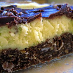 Nanaimo bars originate from the city of Nanaimo and consist of a crumb and nut base, custard middle, and ganache top layer