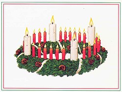 An advent wreath as designed by Johann Hinrich Wichern. On Christmas, the Christ Candle in the center of the wreath is traditionally lit in many church services.