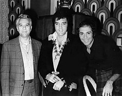 Presley (center) with friends Bill Porter (left) and Paul Anka (right) backstage at the Las Vegas Hilton on August 5, 1972