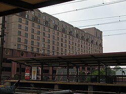 Southbound platform of NJ Transit's New Brunswick station. University Center at Easton Avenue is in the background.