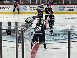 Jack McBain, Logan Cooley, and Dylan Guenther line up for a faceoff during Utah's first preseason game in September 2024.